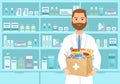 Male pharmacist in white coat holding medicines in paper bag Royalty Free Stock Photo