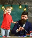 Art lesson concept. Talented artist spend time with son. Child cheerful and teacher painting, drawing. Teacher with Royalty Free Stock Photo