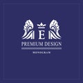 Art logo design. Capital letter E. Elegant emblem with crown, dragon wings. Beautiful creative monogram. Graceful sign for Royalty Royalty Free Stock Photo