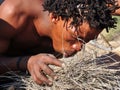 The art of making a bush-fire: Naro-Bushmen near Ghanzi in the C Royalty Free Stock Photo