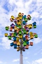 Art object tree of birdhouses against the sky