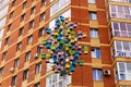 Art object tree of birdhouses on the background wall of an apartment building