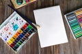 Art painting, color pencils, brushes, watercolor paints, paper and crayon pastel chalks. Flat lay on wooden table Royalty Free Stock Photo