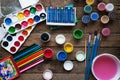 Art of Painting. Paint buckets on wood background. Different paint colors painting on wooden background. Painting set: brushes, pa Royalty Free Stock Photo