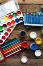 Art of Painting. Paint buckets on wood background. Different paint colors painting on wooden background. Painting set: brushes, pa Royalty Free Stock Photo