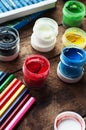 Art of Painting. Paint buckets on wood background. Different paint colors painting on wooden background. Painting set: brushes, pa Royalty Free Stock Photo