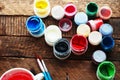 Art of Painting. Paint buckets on wood background. Different paint colors painting on wooden background. Painting set: brushes, pa Royalty Free Stock Photo