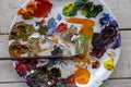 Art palette and brush with lots of colors, tempera and oil paint Royalty Free Stock Photo