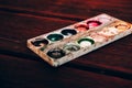Art Palette with empty Colorful Paints Close up on a mahogany table. Empty and used multi-colored paint Royalty Free Stock Photo