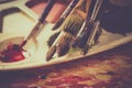 Art palette, watercolors, brushes and water Royalty Free Stock Photo