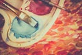 Art palette, watercolors, brushes and water Royalty Free Stock Photo