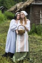 Art Photo of Beautiful Country Girls with Basket of Fresh Bread. Posing Together Embraced in Countryside Outdoor Royalty Free Stock Photo