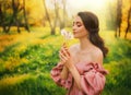 Art photo happy woman holding blowing on dandelion flowers in her hands. Fantasy girl princess enjoys nature, beautiful Royalty Free Stock Photo