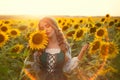 Art photo Happy young rural woman. beautiful growing blooming field Yellow flowers. Cute Girl, blonde holding sunflower Royalty Free Stock Photo
