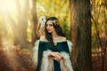 Art photo portrait Fantasy woman goddess elf white bird owl barn owl sits on shoulder. Autumn orange forest trees Royalty Free Stock Photo