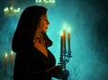 Art photo real people. fantasy blonde mystical woman vampire queen holding candlestick candles burning in hands vintage Royalty Free Stock Photo