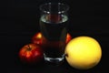 Art photo ripe yellow melon with red apples and a glass of water on a black background Royalty Free Stock Photo