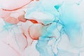 art photography of abstract fluid alcohol ink painting, blue, red and turquoise colors with paper texture Royalty Free Stock Photo