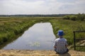 Child fishing on the bank of the river Royalty Free Stock Photo