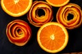 Art photography. A mandarin is served on a dark stone with a decor of a peel citrus.