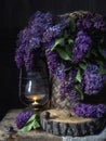 Still life with lilacs and a burning lantern Royalty Free Stock Photo