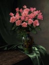 Still life with bouquet of red roses in copper vase Royalty Free Stock Photo