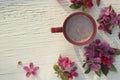 Art pink spring flowers frame with cup on old white wood background. Royalty Free Stock Photo