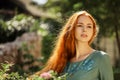 Art portrait of beautiful girl with long red hair