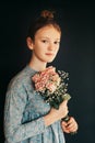 Pretty young girl wth soft bouquet of pink roses