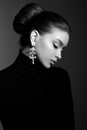 Art portrait woman in black turtleneck. Hair high beam, perfect profile face. Elegant beauty style. Earrings in the ears Royalty Free Stock Photo