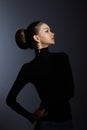 Art portrait woman in black turtleneck. Hair high beam, perfect profile face. Elegant beauty style. Earrings in the ears Royalty Free Stock Photo