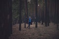 Woman in the autumn dark forest