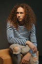 Portraits of a guy with an attractive appearance, curly hair and stylish clothes Royalty Free Stock Photo