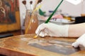 Art restorer works on ancient gilded icon Royalty Free Stock Photo