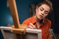 Art school class. Portrait of female painter creating abstract artwork in studio. Female painter drawing on a canvas. Royalty Free Stock Photo