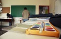 Art school classroom displaying watercolor paint box and chalkboard