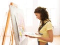 Student girl with easel painting at art school Royalty Free Stock Photo