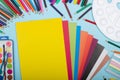 Art school supplies for painting and a set of colored paper on a blue background Royalty Free Stock Photo