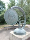art sculpture of a bare tree with partial tire and a medallion with children playing Sturbridge, Ma