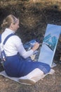 An art student painting a scenic,