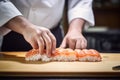 The art of sushi making: chef prepares salmon delights