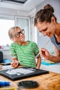 Art teacher helping a student with painting Royalty Free Stock Photo