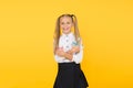 Art training. Happy girl holding school scissors on yellow background. Small girl preparing for arts and crafts classes Royalty Free Stock Photo