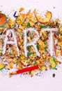 Art word on the background of colored pencil shavings Royalty Free Stock Photo