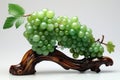 The art work of a bunch of grapes with leaves made of green jade which is placed on the shining wooden base.