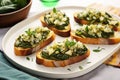 artful arrangement of simple spinach and artichoke bruschetta on rectangular plates