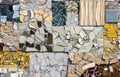 Artful mosaic design of assorted broken tile on the side of a building.