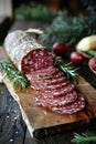 Artful presentation of sliced salami on a wooden board. Royalty Free Stock Photo