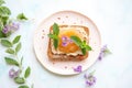 artfully arranged almond butter toast with a sprig of mint on top