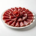 Artfully arranged thinly sliced ham presented as a flower on a white plate Royalty Free Stock Photo